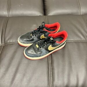 Nike Black and Red Sneakers with Gold Swoosh